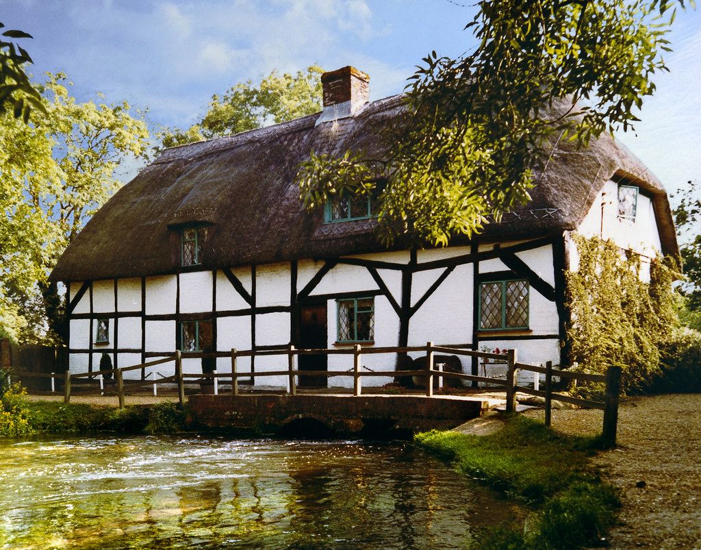 The Fulling Mill - a thatched building sitting over the river.